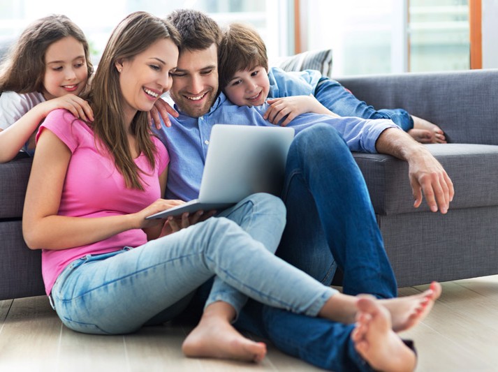 4307135331528-family-looking-at-computer-smiling-sm-16734580362602.jpg