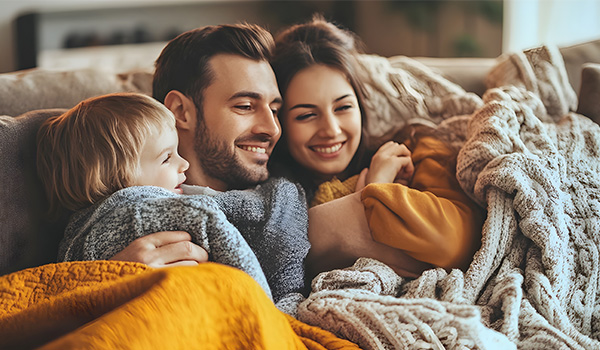 family huddled together on couch