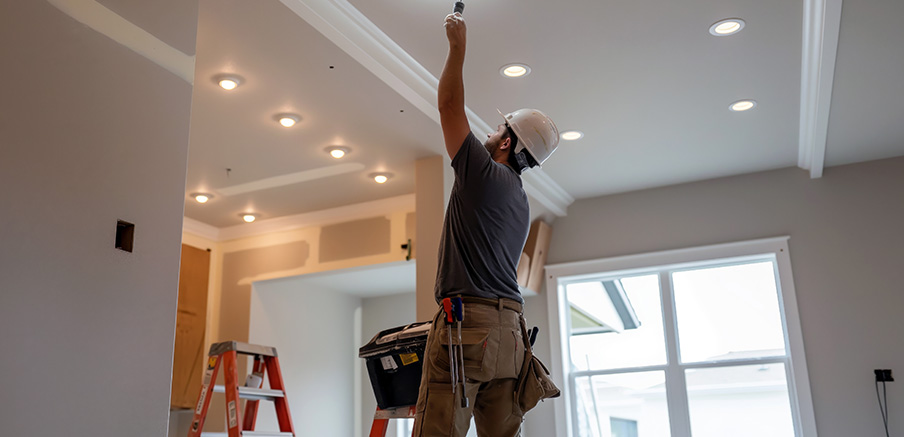 Electrician installing a new light fixture