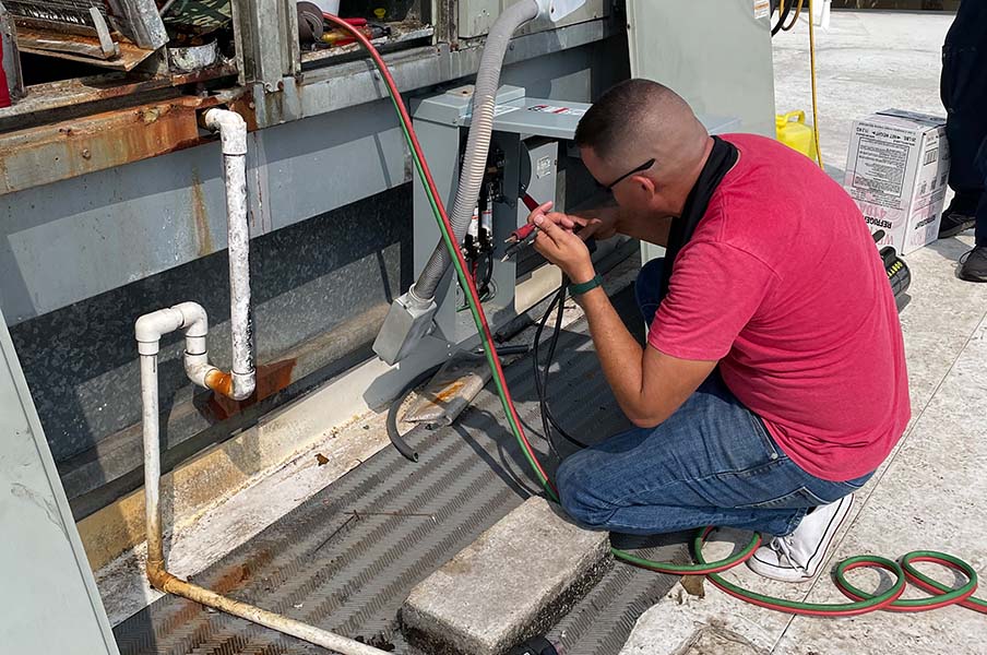 Go Green Air technician repairing hvac system