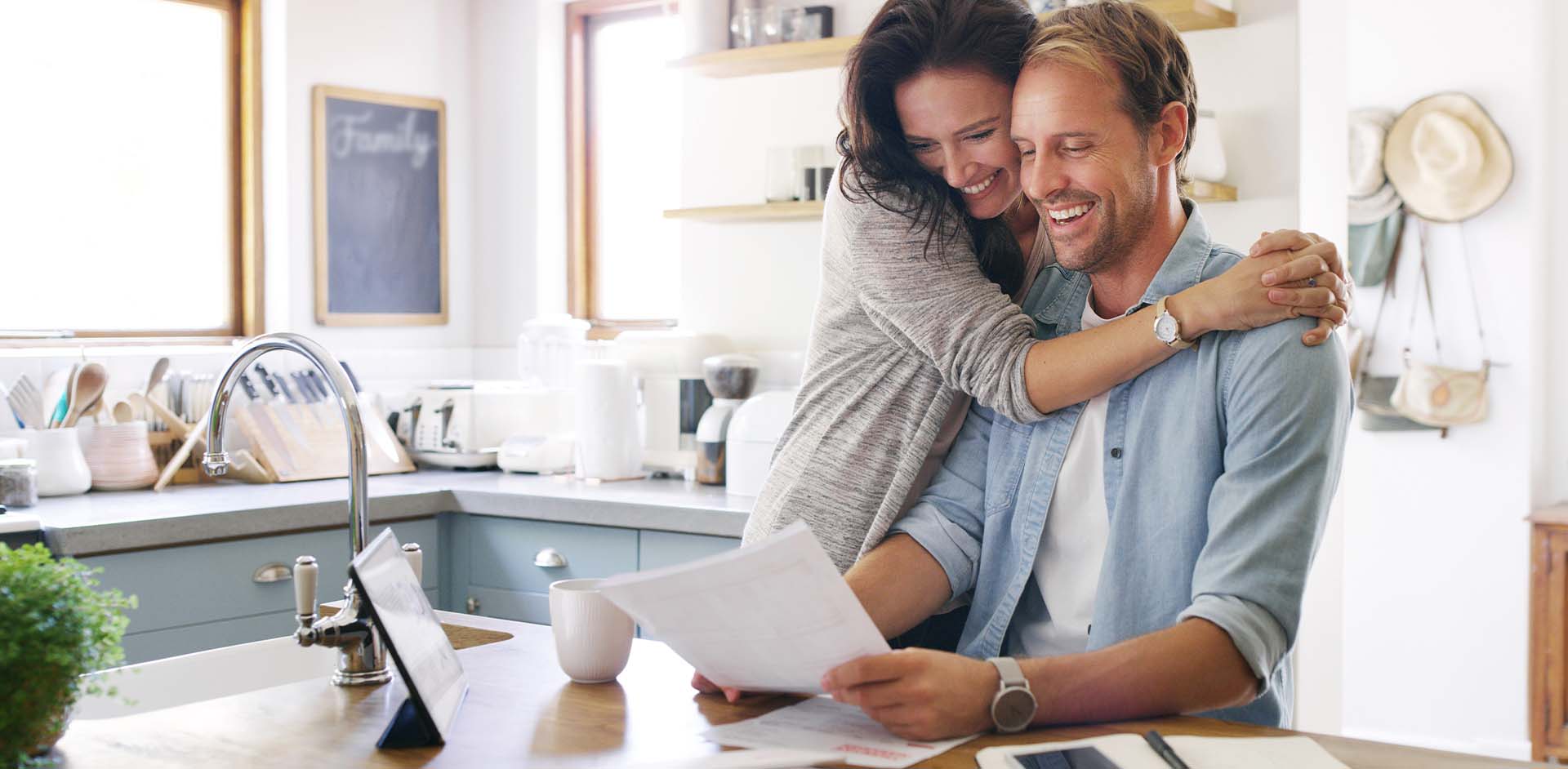 r66-woman-huging-man-reading-in-kitchen-17476697925994.jpg