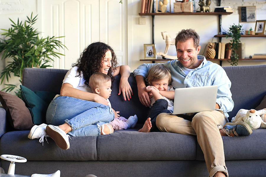 happy family sitting on couch 