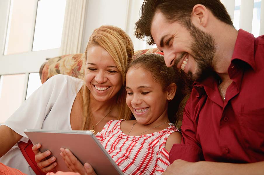 2648-happy-family-laughing-looking-at-video-on-tablet-computer-17377551422101.jpg