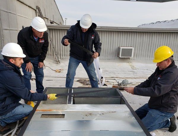 HVAC technicians working on roof